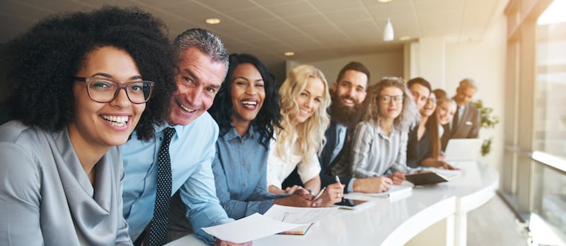 A multicultural group of business people smiling.