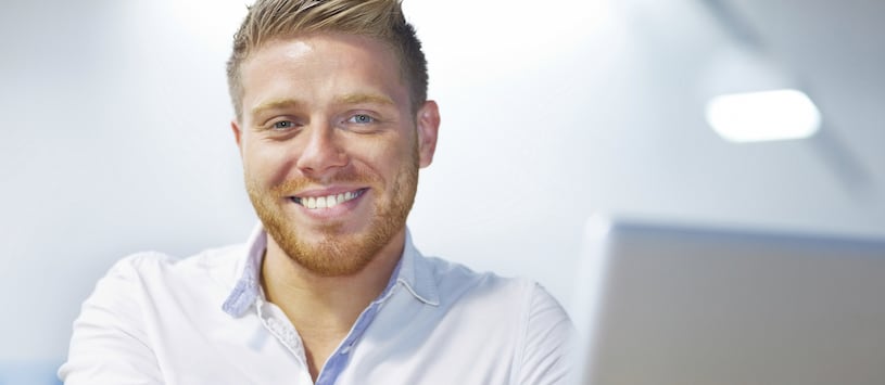 An Accounting and Payroll professional smiling at their computer