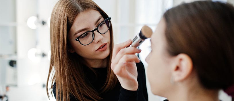 A woman applying makeup. Take your Advanced Esthetics and Spa Operations Program at Oxford.