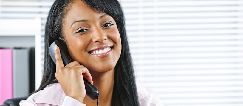 A pretty woman holding a phone to her ear